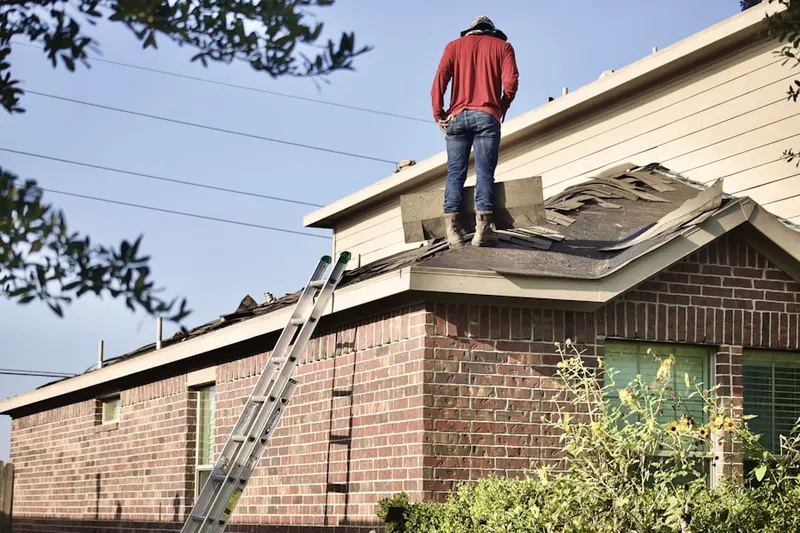 Professional roofer working on a residential roof in Towne Crossing